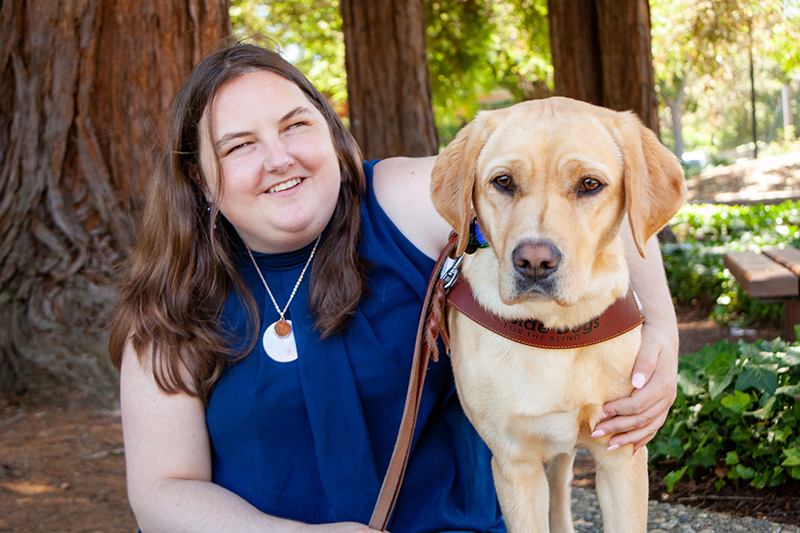 Portrait of Claire Stanley with her guide dog, Tulane.