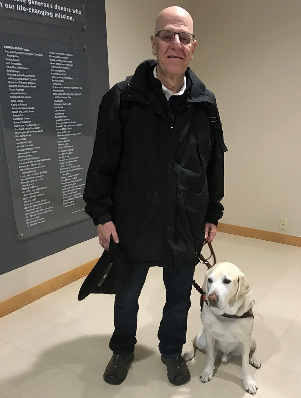 Bill Faulkner and his guide dog Armstrong pose for a photo