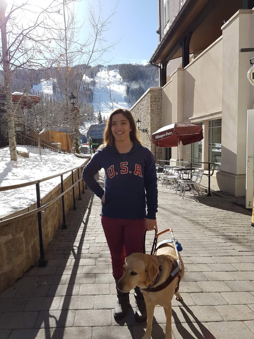 Letticia walks through the Olympic Village in Colorado Springs with her guide dog, Philly.
