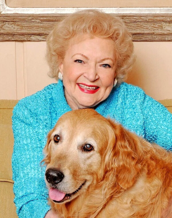 Betty embraces her Golden Retriever, Pontiac, who she adopted from GDB.