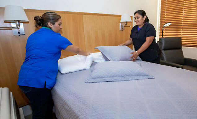 Housekeeping staff prepare a room for client residents.