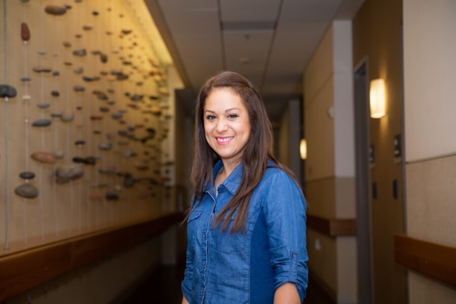 A woman stands in the hallways of the client residence.
