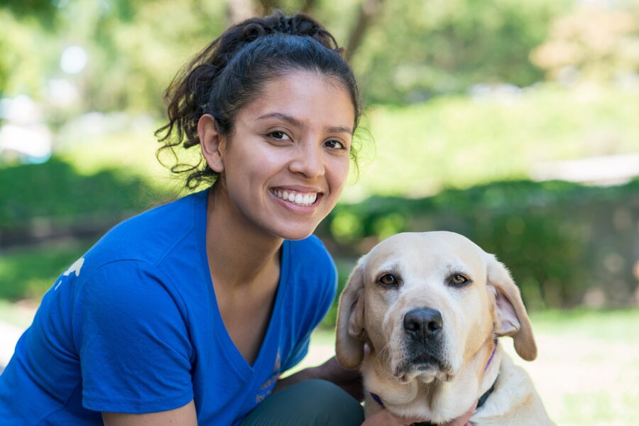 A portrait of Maria with a yellow Lab.