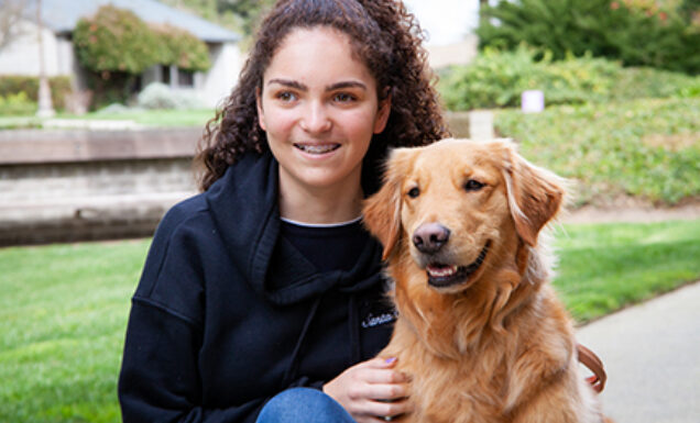 A young girl with a Golden Retriever K9 Buddy dog.