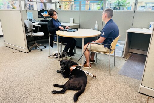 A guide dog handler and a student conduct an informational interview.