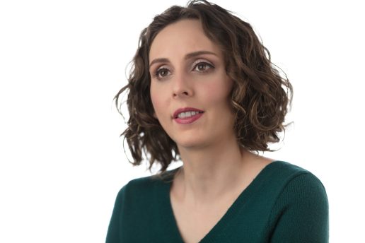 Headshot of Dr. Arielle Silverman. She has brown curly hair and is wearing a dark green top.