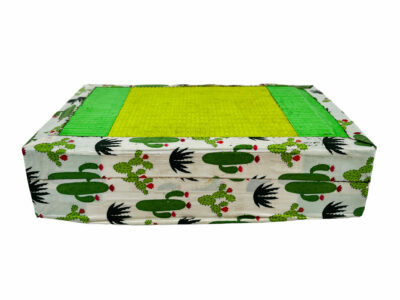 A square object wrapped in colorful duct tape with a piece of yoga mat taped to the top.