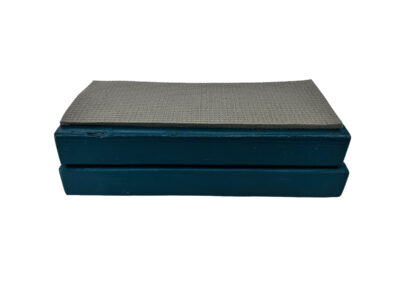 Two stacked wooden blocks with a piece of yoga mat adhered to the top.