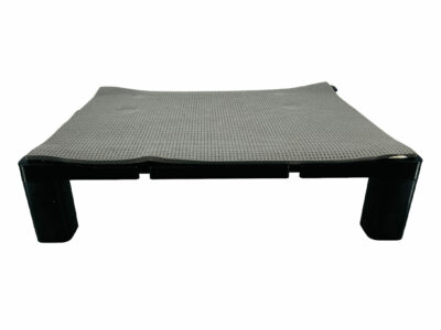 A rectangular shaped computer monitor riser with a piece of yoga mat adhered to the top.