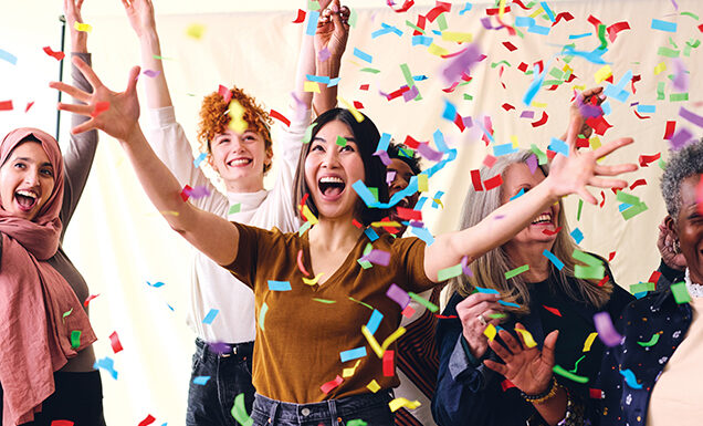 Confetti falls on a group of celebratory people