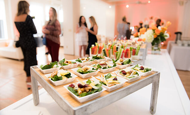 Table of appetizers and with people mingling in the background