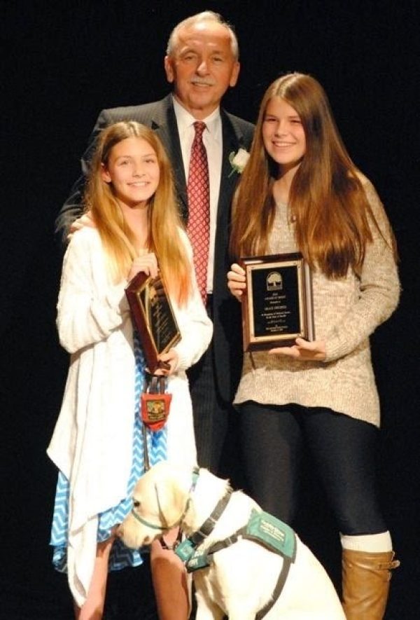 Giordan Gitchell, Danville Mayor Newell Arnerich, Grace Gitchell, and guide dog puppy Vidal (yellow Lab).