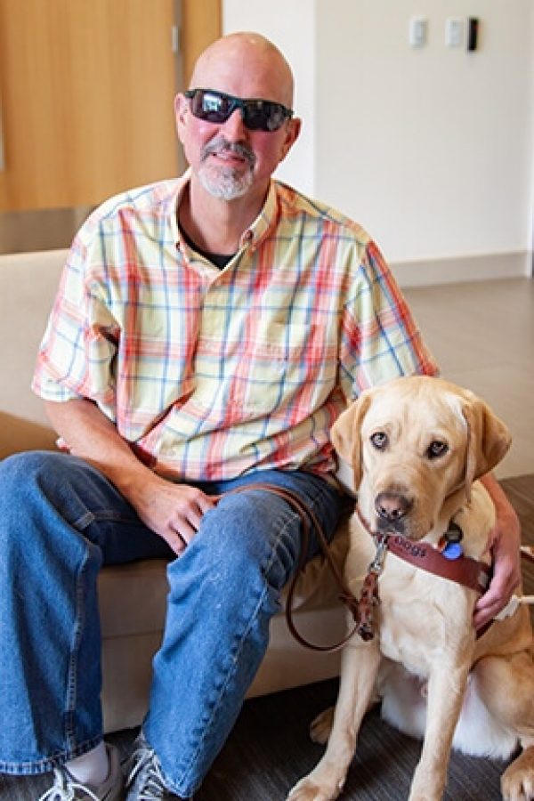GDB graduate Barry Simmons with his guide dog, a yellow Lab named Virgo.